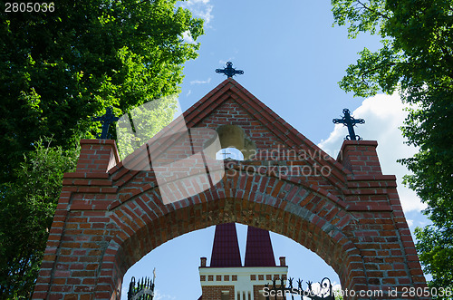 Image of gothic church gate with metallic crosses  