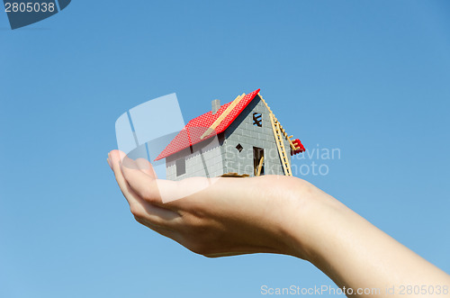 Image of house in palm on blue sky house purchase concept 