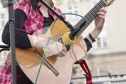 Image of Woman playing guitar