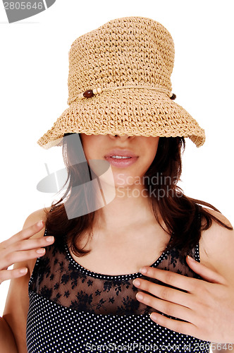 Image of Girl with hat over eye's.