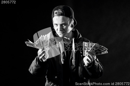 Image of a young man with money in hands