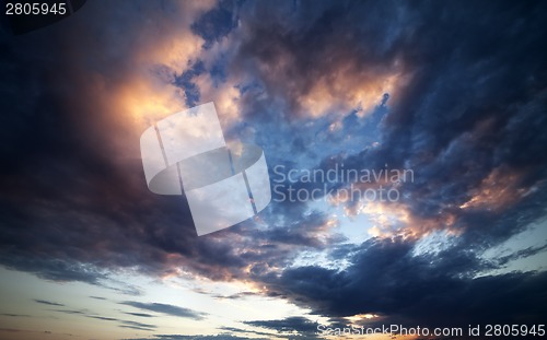 Image of Dark clouds at sunset. Wide angle view.