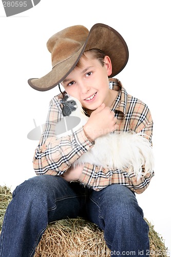 Image of Farm boy holding a chicken