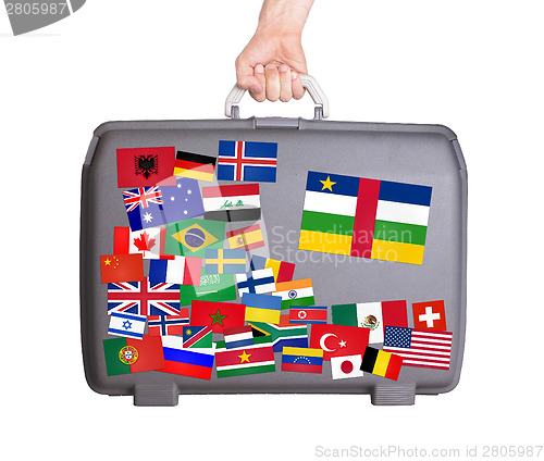 Image of Used plastic suitcase with stickers