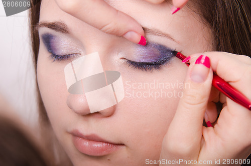 Image of Makeup artist paints eyelashes with makeup. Close-up