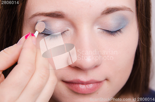 Image of Makeup artist applies eye shadow model