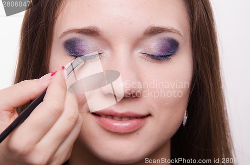 Image of Makeup artist embellish eyelashes of a beautiful girl