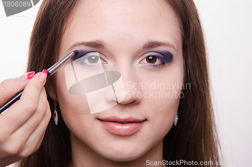 Image of Makeup artist paints a model ever