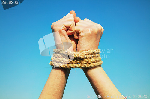 Image of Hands tied up with rope