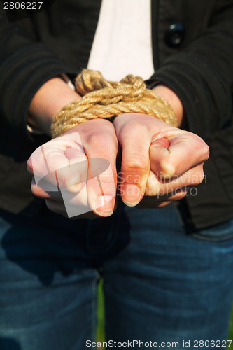 Image of Hands tied up with rope