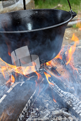 Image of big cauldron on campfire