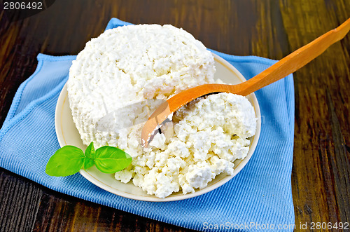 Image of Curd with a wooden spoon on board