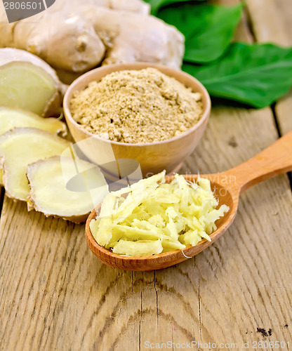 Image of Ginger powder and grated on board with root and leaves