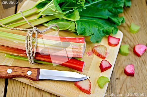 Image of Rhubarb cut with a leaf on board