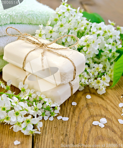 Image of Soap with towel and bird cherry on board