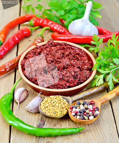 Image of Adjika with hot pepper and spices on board