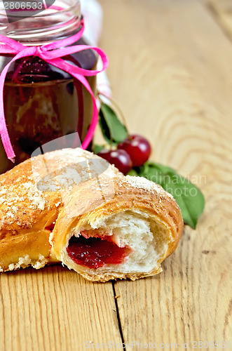 Image of Bun with cherry jam on board