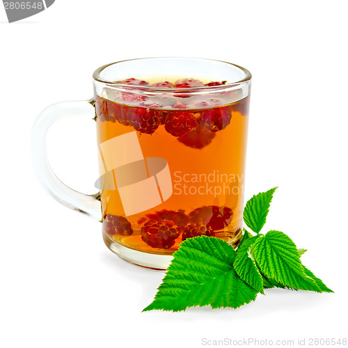 Image of Tea with raspberry and green leaf in glass mug