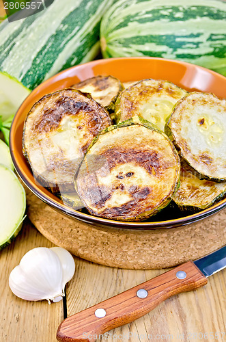 Image of Zucchini fried with a knife on board