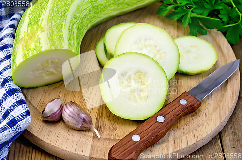 Image of Zucchini green with napkin on board