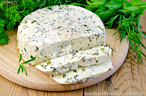 Image of Cheese homemade round with spices on board