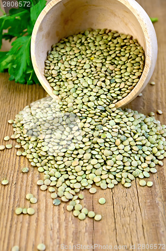 Image of Lentils green in wooden bowl on board