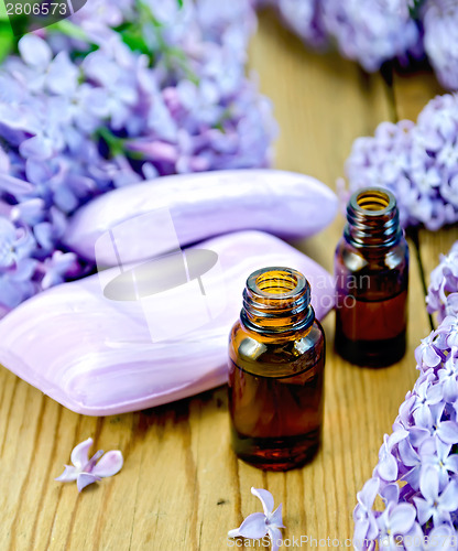 Image of Oil with soap and lilacs on the board