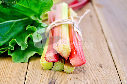 Image of Rhubarb tied with twine with leaf on board