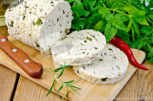 Image of Cheese homemade with hot pepper and rosemary on board