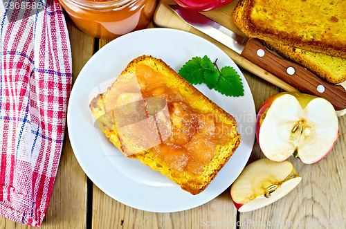 Image of Bread with apple jam in plate on board