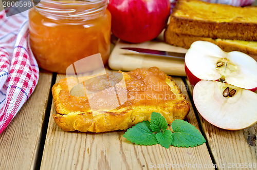 Image of Bread with apple jam and apples on board