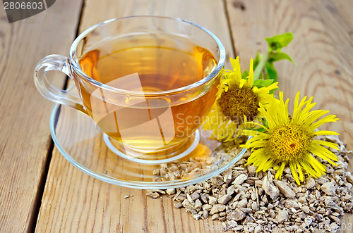 Image of Herbal tea from root of elecampane with flower on board