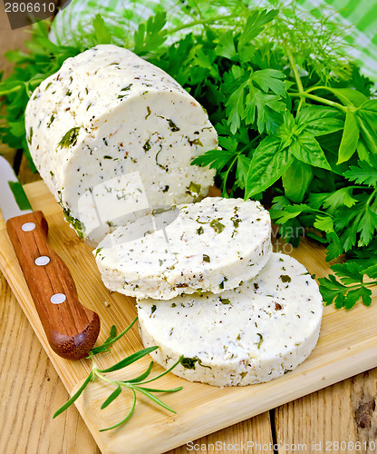 Image of Cheese homemade with spices and napkin on board