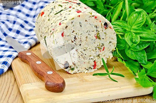 Image of Cheese homemade with hot pepper and napkin on board