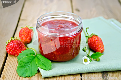 Image of Jam of strawberry with berries and leaf on board