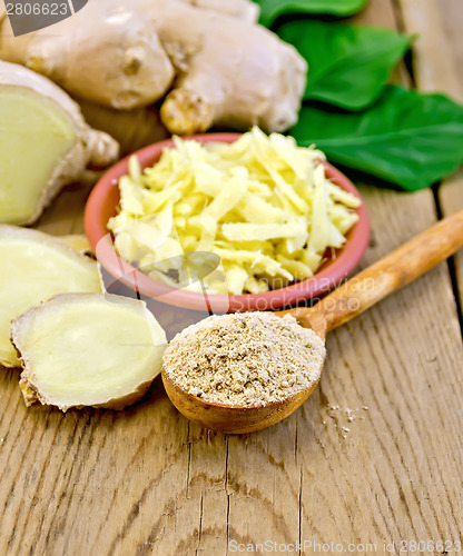 Image of Ginger powder and grated with root and leaves on board