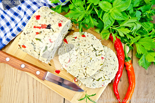 Image of Cheese homemade with hot pepper and knife on board