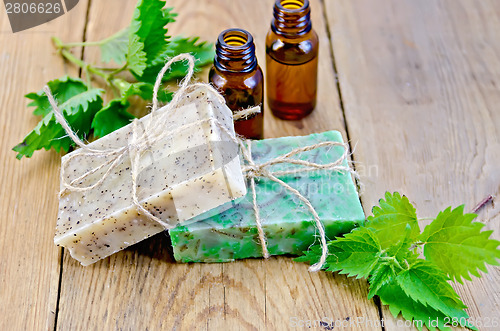 Image of Soap homemade and oil with nettle on board