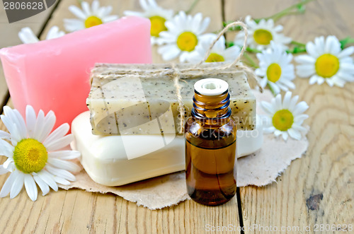 Image of Oil with different soap and camomile on board