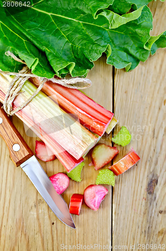 Image of Rhubarb cut with leaf on a wooden board