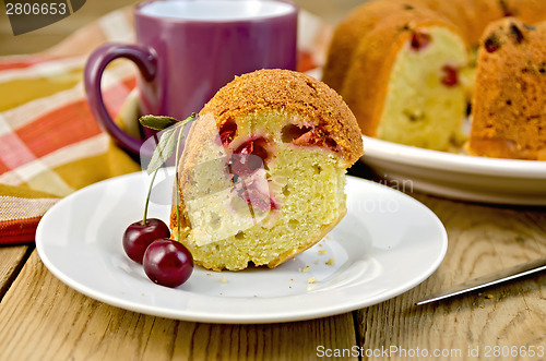 Image of Cake with cherries and plate on board