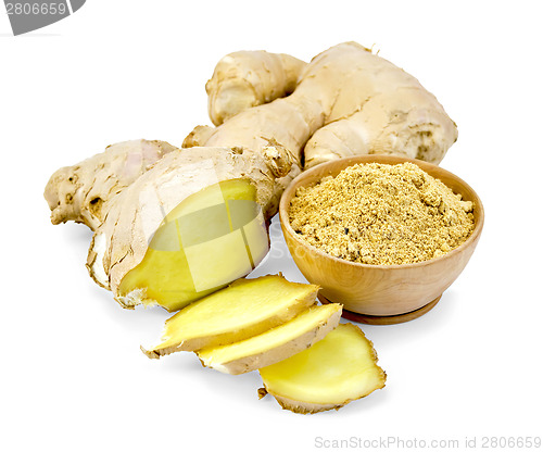 Image of Ginger powder in wooden bowl with root