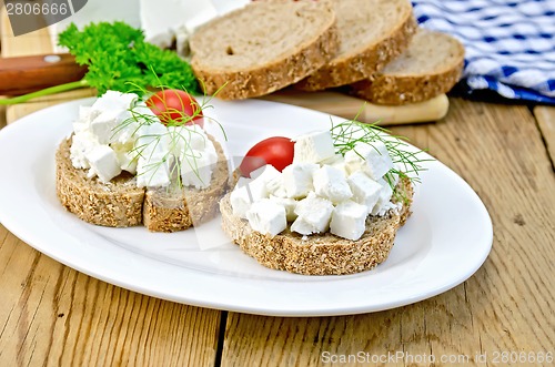 Image of Bread with cheese and tomatoes in white plate