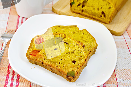 Image of Fruitcake pumpkin with candied fruit on plate and napkin