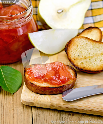 Image of Bread with pear jam and leaf on board