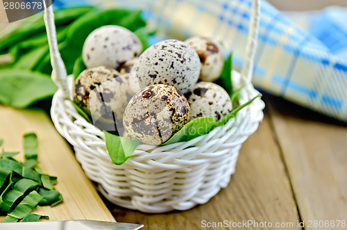 Image of Eggs quail in basket with sorrel on board