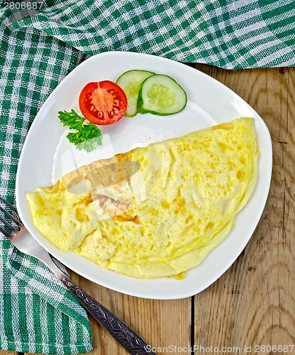 Image of Omelet with green napkin on board