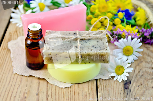 Image of Soap with oil and wildflowers on board