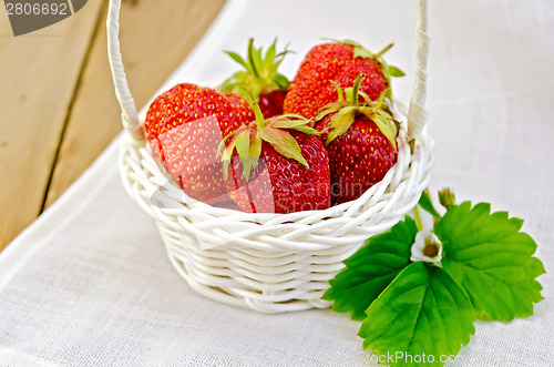 Image of Strawberries in basket on napkin and board