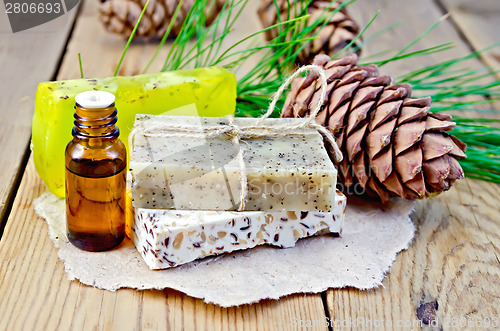 Image of Oil and soap different cedar cones on board